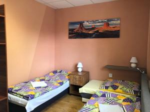 a bedroom with two twin beds and a night stand at Ubytovanie Poprad in Poprad