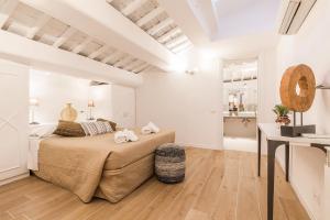 a white bedroom with a bed and a desk at Thebestinrome Orbitelli in Rome