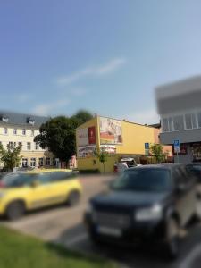 a blurry picture of a street with cars and buildings at Ubytovanie Poprad in Poprad