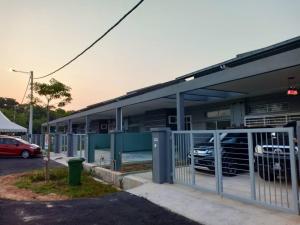 a building with a parking lot with a car garage at Ana Homestay Ayer Keroh Melaka in Ayer Keroh