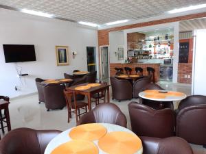 um restaurante com mesas e cadeiras e um bar em Hotel Bruggemann em Florianópolis