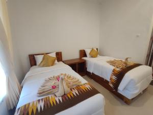 Postel nebo postele na pokoji v ubytování Gedhong Hostel
