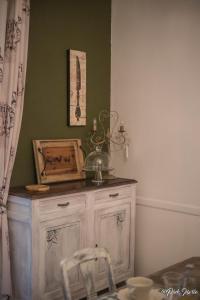 a room with a wooden cabinet and a chair at Chambres d'hôtes Le Pessac in Vielmur