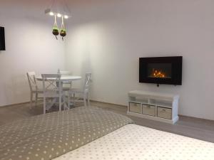 a bedroom with a bed and a table with a fireplace at BrasovApart Piata Sfatului 2 in Braşov