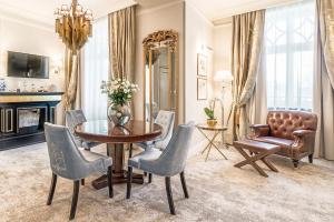 a dining room with a table and chairs and a mirror at Bachleda Luxury Hotel Krakow MGallery Hotel Collection in Krakow