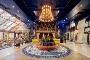 a lobby with a fireplace and a chandelier at Kempinski Hotel Bahía Beach Resort & Spa in Estepona