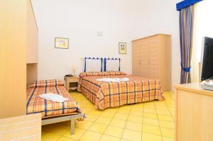 เตียงในห้องที่ Albergo Villa Giusto