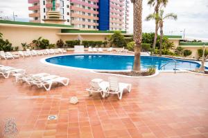 una piscina con tumbonas y un complejo en New 2 bedroom apartment in Playa Paraiso, PP/42, en Playa Paraiso