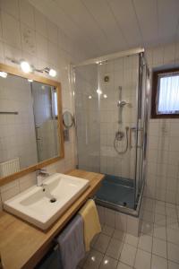 a bathroom with a sink and a shower at Seepension Neubacher KG in Nussdorf am Attersee