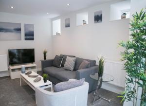 a living room with a couch and a tv at 71 East Parade in Harrogate