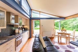 a kitchen and living room with a couch and a table at The Bothy - An Oasis 5 Mins to St Andrews in St. Andrews