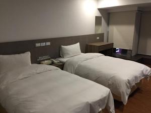 Postel nebo postele na pokoji v ubytování Wish Hotel