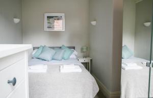 a bedroom with two beds with blue pillows at Harlow apartment in Harrogate