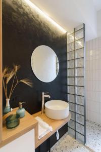 La salle de bains est pourvue d'un lavabo et d'un miroir. dans l'établissement SUNRISE apartment, à Lviv