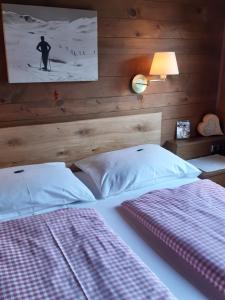 a bedroom with a bed with a picture on the wall at Pension Feiersinger in Kitzbühel