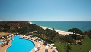 an aerial view of a resort with a swimming pool and a beach at PortoBay Falesia in Albufeira