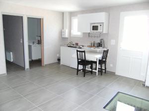 a kitchen with a table and chairs in a room at La maison de Louna in Saint-Parres-lès-Vaudes +9 photos