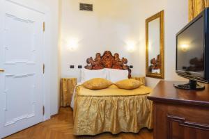 a hotel room with a bed and a television at Charles Bridge Palace in Prague