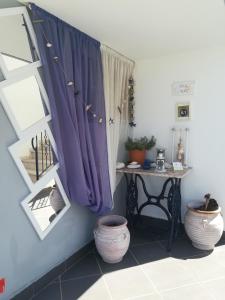a room with a window with purple curtains and a table at Villa Teo in Kalamata