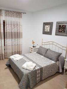 Ένα ή περισσότερα κρεβάτια σε δωμάτιο στο Apartamentos HELA