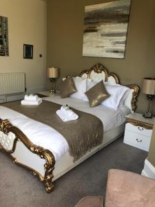 a bedroom with two beds with towels on them at Washington House Hotel in Bournemouth