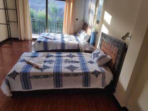 Ein Bett oder Betten in einem Zimmer der Unterkunft Merkeza Guest House