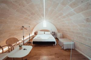 a room with a bed in a brick walled room at Gradelle San Nicola in Matera