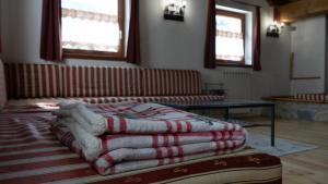 a pile of blankets sitting on a table in a room at Due Parchi B&B in Vezza dʼOglio