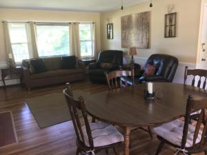 a living room with a table and chairs and a couch at Highland Lake Resort in Bridgton