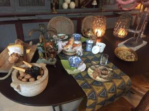 a table with plates of food on it at La Maison Rousseau Chambre d'hôtes in Nîmes