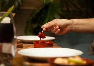 a person eating food on a table with plates of food at The Kings Arms Hotel in Malmesbury