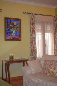 a living room with a couch and a window at CASA BLANCAFLOR in Peñaflor
