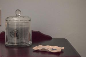 a glass jar on a table with a plastic spoon at CASA BLANCAFLOR in Peñaflor +28 photos