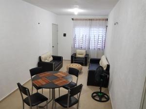 a living room with a table and chairs at Casa en Mahahual cerca de la playa in Mahahual