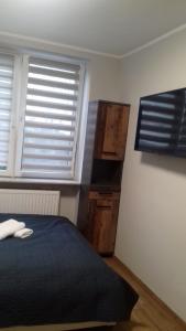 Łóżko lub łóżka w pokoju w obiekcie APARTAMENTY CENTRUM PAŁACOWA