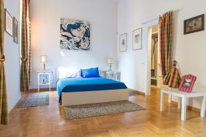 a bedroom with a blue bed in a room at Flowers' Lane in Milan