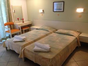 Postel nebo postele na pokoji v ubytování Captain's Hotel