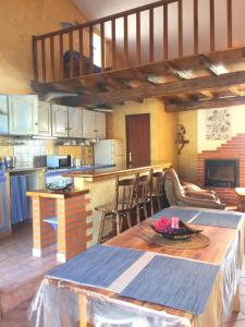 a large kitchen with a table and a kitchen with at Quinta Forum in Tocha