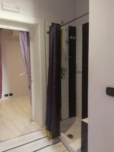 a bathroom with a shower and a glass door at Gatto Bianco Casa Dei Venti in Bari