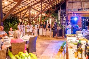 a group of people standing in front of a wedding ceremony at Refugios Parajuru - Casa Verde in Parajuru