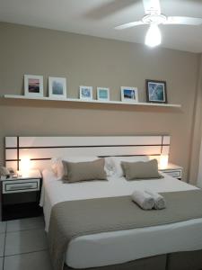 a bedroom with a large white bed in a room at Hotel Marlen in Cabo Frio