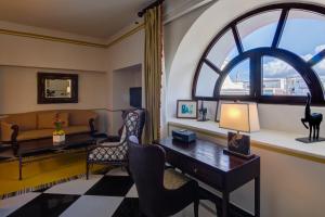 a living room with a desk and a window at Hotel El Convento in San Juan