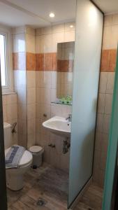 a bathroom with a toilet and a sink at Nafsika Hotel in Rhodes Town