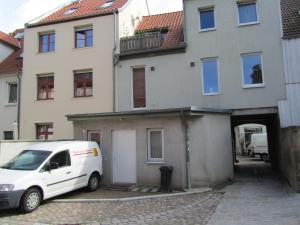 a white van parked in front of a building at Altstadt Ferienwohnung in Wismar