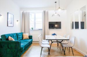 a living room with a blue couch and a table at AAA STAY Premium Apartments Old Town Warsaw in Warsaw