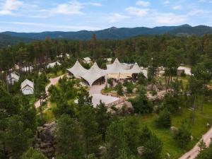 an aerial view of a building in the woods at Under Canvas Mount Rushmore in Keystone