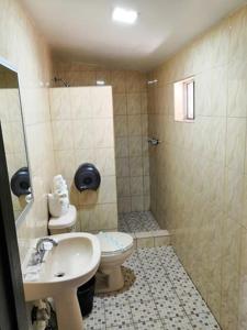 a bathroom with a toilet and a sink at Motel Ranchito in Ensenada