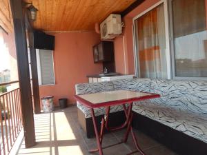 a red table on the balcony of a house at Dunav Apt.3 in Ravda