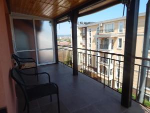 a balcony with a view of a building at Dunav Apt.3 in Ravda +7 photos