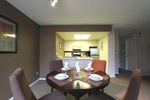 a dining room with a table and chairs and a kitchen at Marquise Condos by Whistler Retreats in Whistler